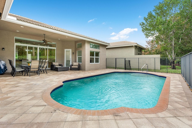 view of pool with ceiling fan and a patio area