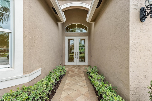 view of exterior entry featuring french doors