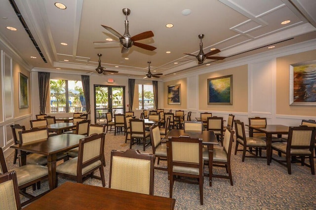 carpeted dining space featuring crown molding, french doors, and a healthy amount of sunlight