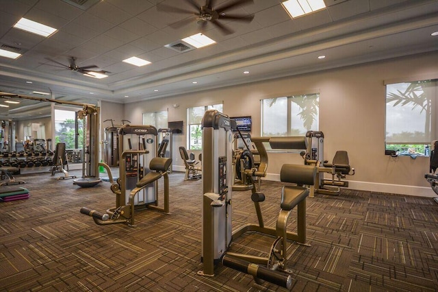 gym featuring ceiling fan and dark colored carpet