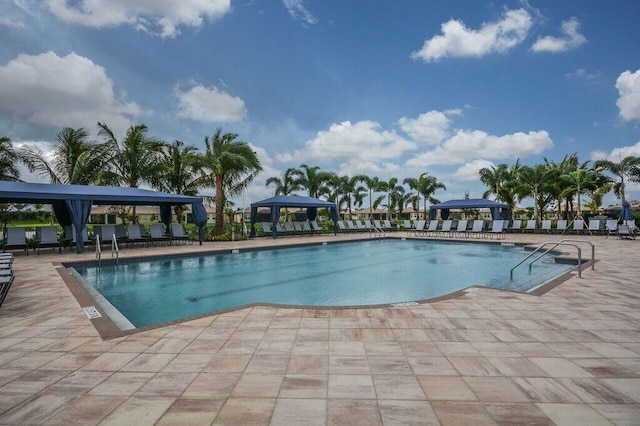 view of swimming pool featuring a patio area and a gazebo