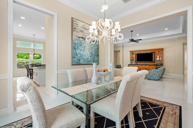 dining room featuring light tile patterned flooring, ceiling fan with notable chandelier, and ornamental molding