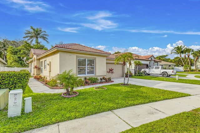 mediterranean / spanish home with a garage and a front lawn