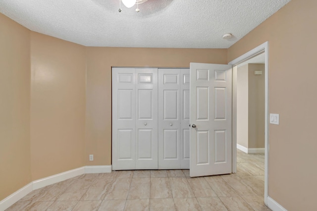 unfurnished bedroom featuring a closet and a textured ceiling