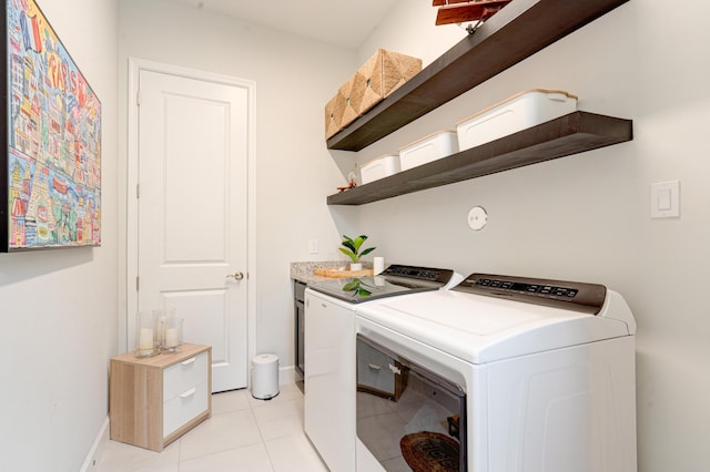 washroom with separate washer and dryer and light tile patterned floors