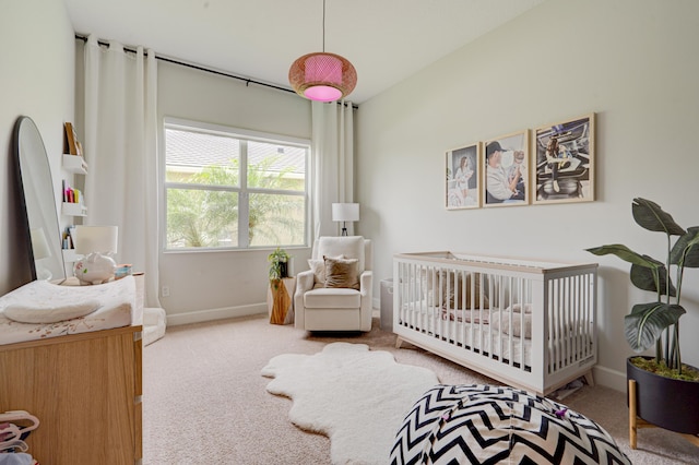 bedroom featuring carpet flooring and a crib