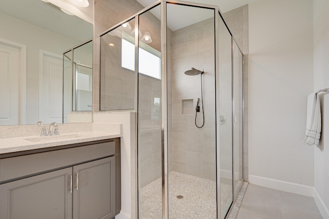 bathroom featuring tile patterned floors, vanity, and a shower with shower door