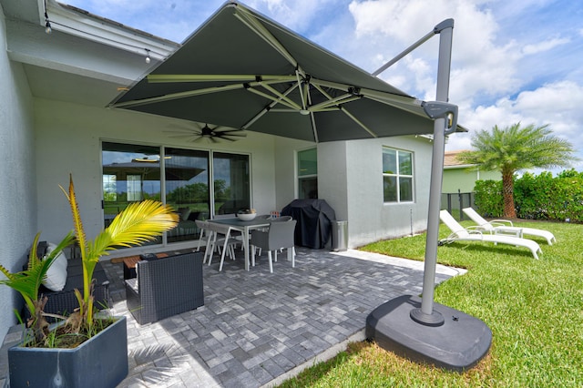 view of patio with ceiling fan and a grill