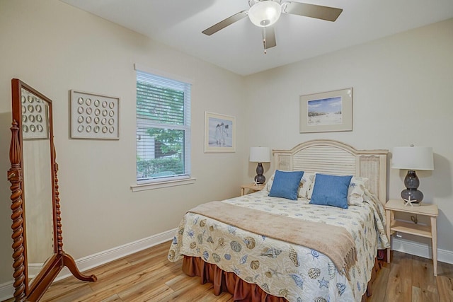 bedroom with ceiling fan and light hardwood / wood-style floors