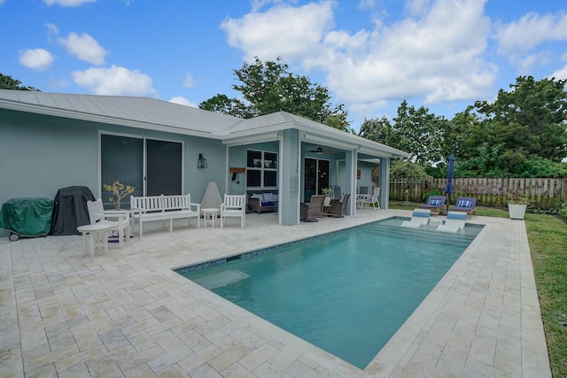 view of pool featuring ceiling fan, an outdoor hangout area, and a patio