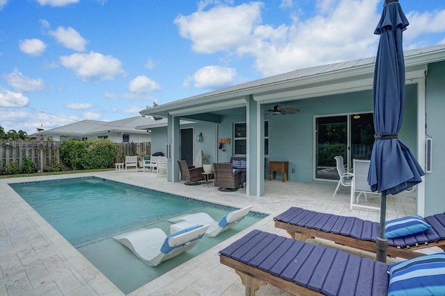 view of pool featuring ceiling fan and a patio