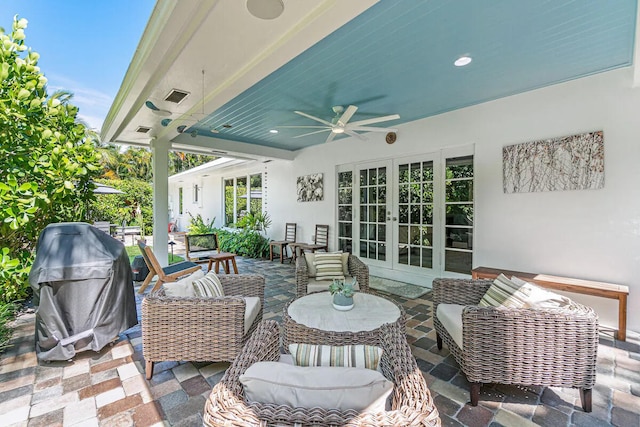 view of patio / terrace with french doors, an outdoor living space, and ceiling fan