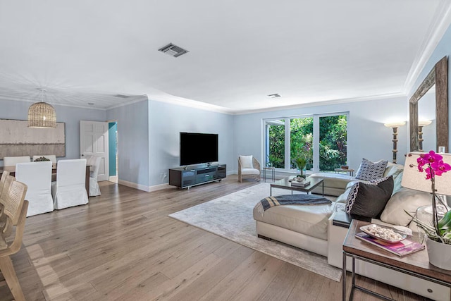 living room featuring hardwood / wood-style floors and crown molding