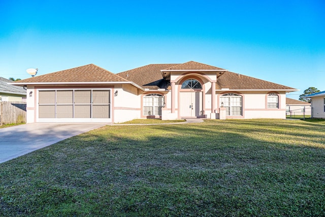 view of front of house with a garage and a front lawn