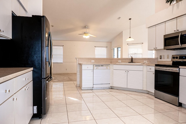 kitchen featuring pendant lighting, white cabinets, stainless steel appliances, and sink