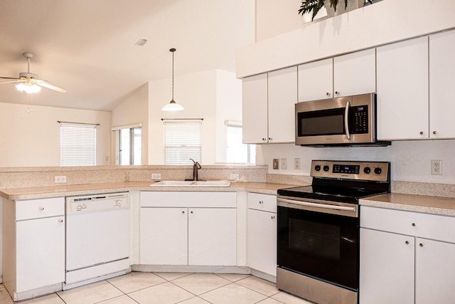 kitchen with white cabinets, decorative light fixtures, and stainless steel appliances