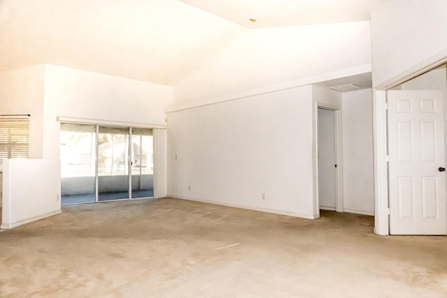 carpeted empty room featuring high vaulted ceiling