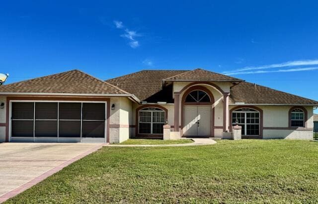 view of front facade with a garage and a front lawn