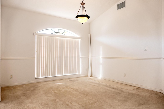 unfurnished room featuring carpet and lofted ceiling