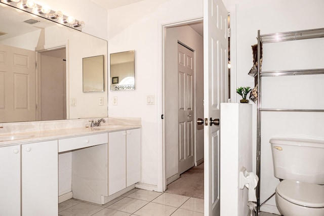 bathroom featuring tile patterned floors, vanity, and toilet