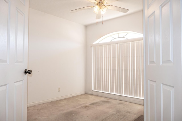 spare room featuring ceiling fan and light colored carpet