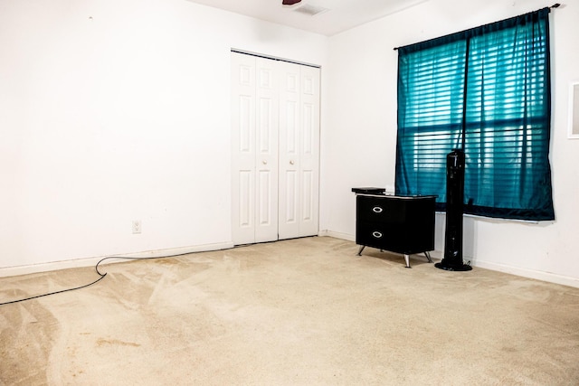 bedroom with carpet flooring and a closet