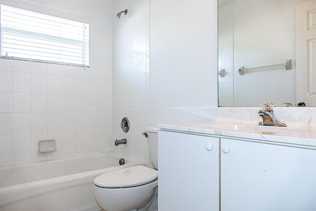 full bathroom with vanity, toilet, and tiled shower / bath