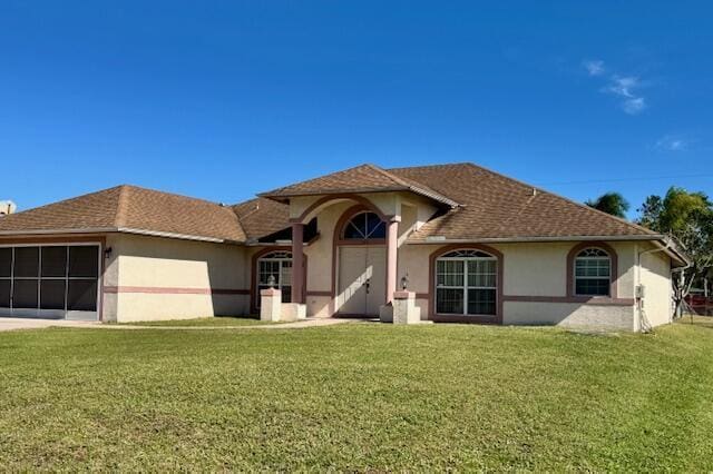 view of front of property with a garage and a front yard