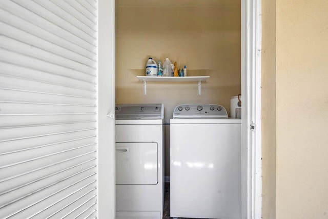 clothes washing area with washing machine and dryer and laundry area