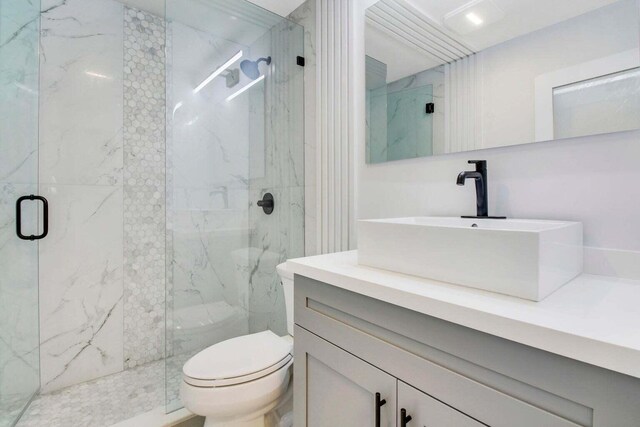 kitchen with stainless steel appliances, sink, decorative light fixtures, a center island, and white cabinetry