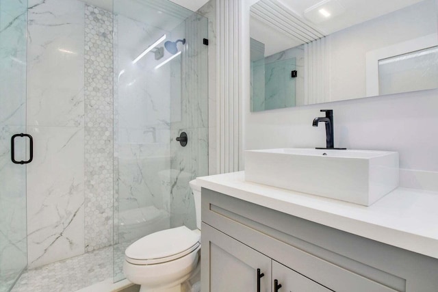 bathroom featuring vanity, an enclosed shower, and toilet