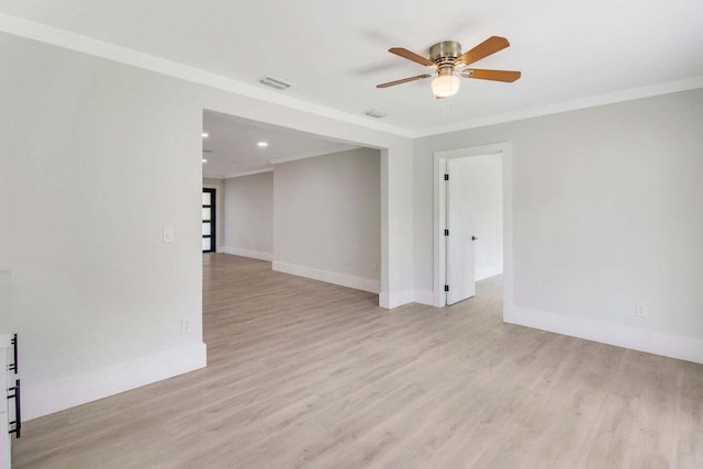 spare room featuring ornamental molding, ceiling fan, and light wood-type flooring