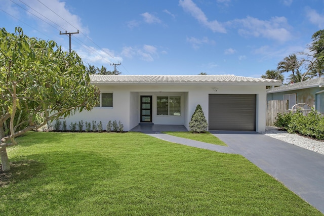 view of front of property featuring a garage and a front lawn