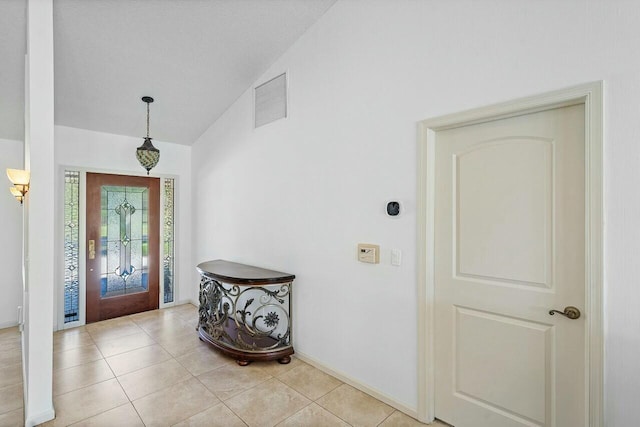 entryway featuring lofted ceiling and light tile patterned flooring