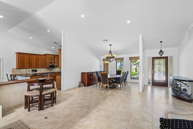 tiled dining space with high vaulted ceiling