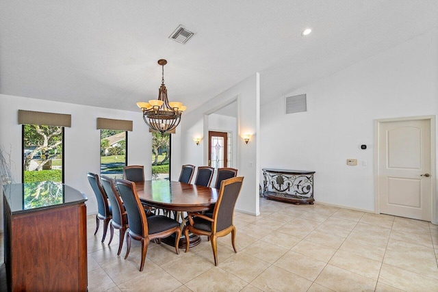 dining area with vaulted ceiling, light tile patterned floors, and a chandelier