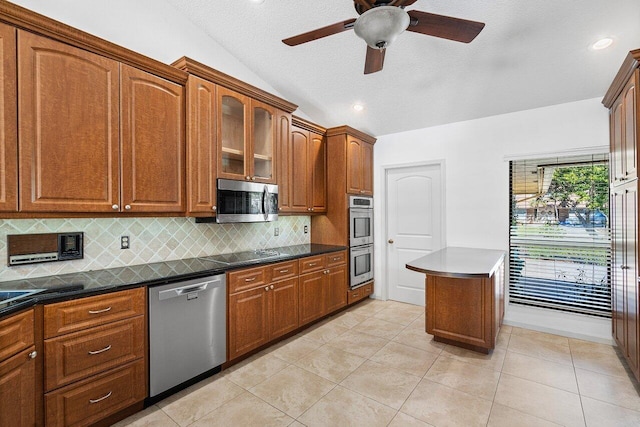 kitchen with stainless steel appliances, light tile patterned floors, tasteful backsplash, lofted ceiling, and ceiling fan