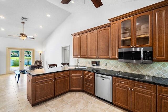 kitchen featuring french doors, tasteful backsplash, high vaulted ceiling, appliances with stainless steel finishes, and light tile patterned flooring