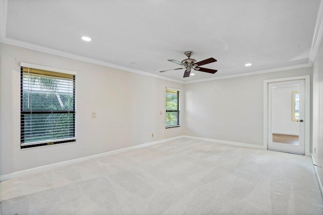 carpeted empty room featuring ceiling fan and crown molding