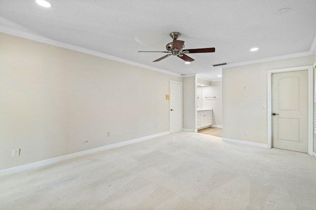 carpeted empty room featuring a textured ceiling, ornamental molding, and ceiling fan