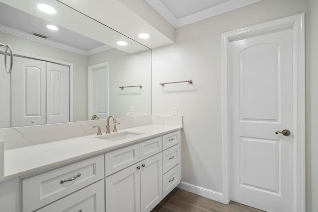 bathroom featuring vanity, crown molding, and hardwood / wood-style floors