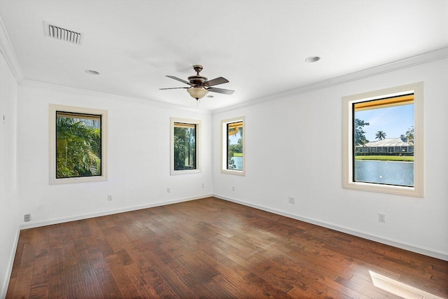 empty room featuring ceiling fan, dark hardwood / wood-style flooring, and crown molding