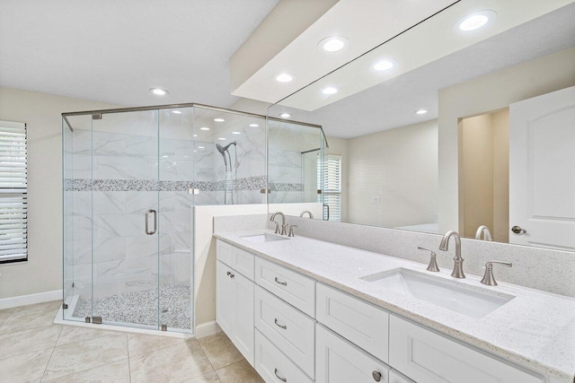 bathroom featuring tile patterned floors, an enclosed shower, and vanity