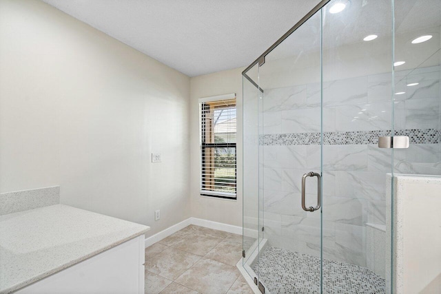 bathroom with an enclosed shower, tile patterned floors, and vanity