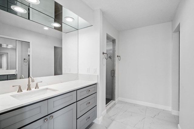 bathroom with a shower with door, a textured ceiling, and vanity