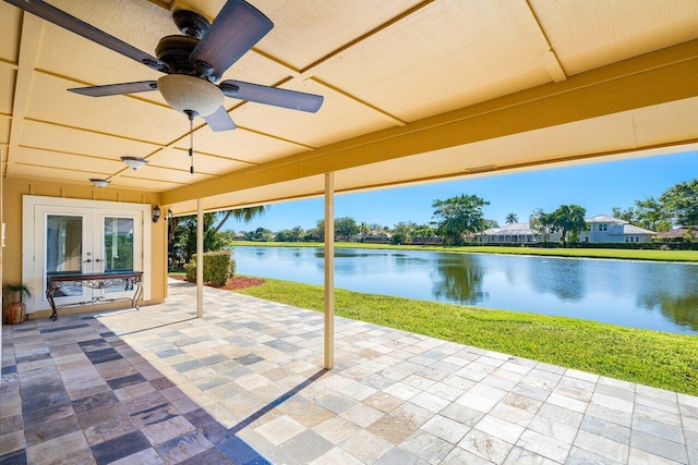 view of patio featuring ceiling fan, french doors, and a water view