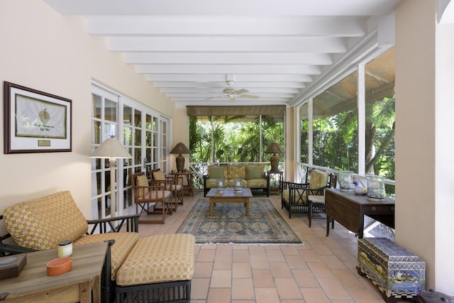 sunroom with beamed ceiling, a wealth of natural light, and ceiling fan