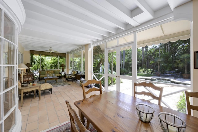 sunroom / solarium featuring ceiling fan, french doors, and beamed ceiling