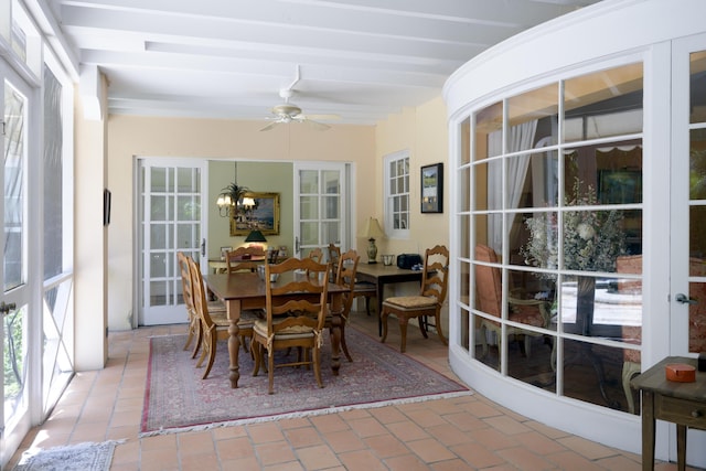 sunroom / solarium with ceiling fan with notable chandelier, beam ceiling, and french doors