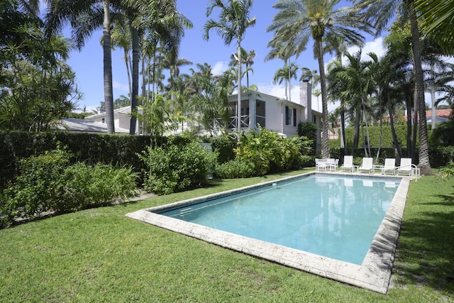 view of pool featuring a lawn